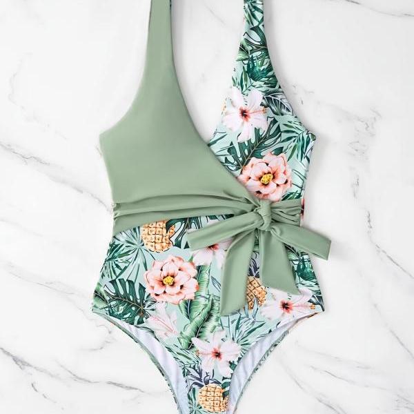 A one-piece cross strap swimsuit with sexy and slimming print beach vacation bikini